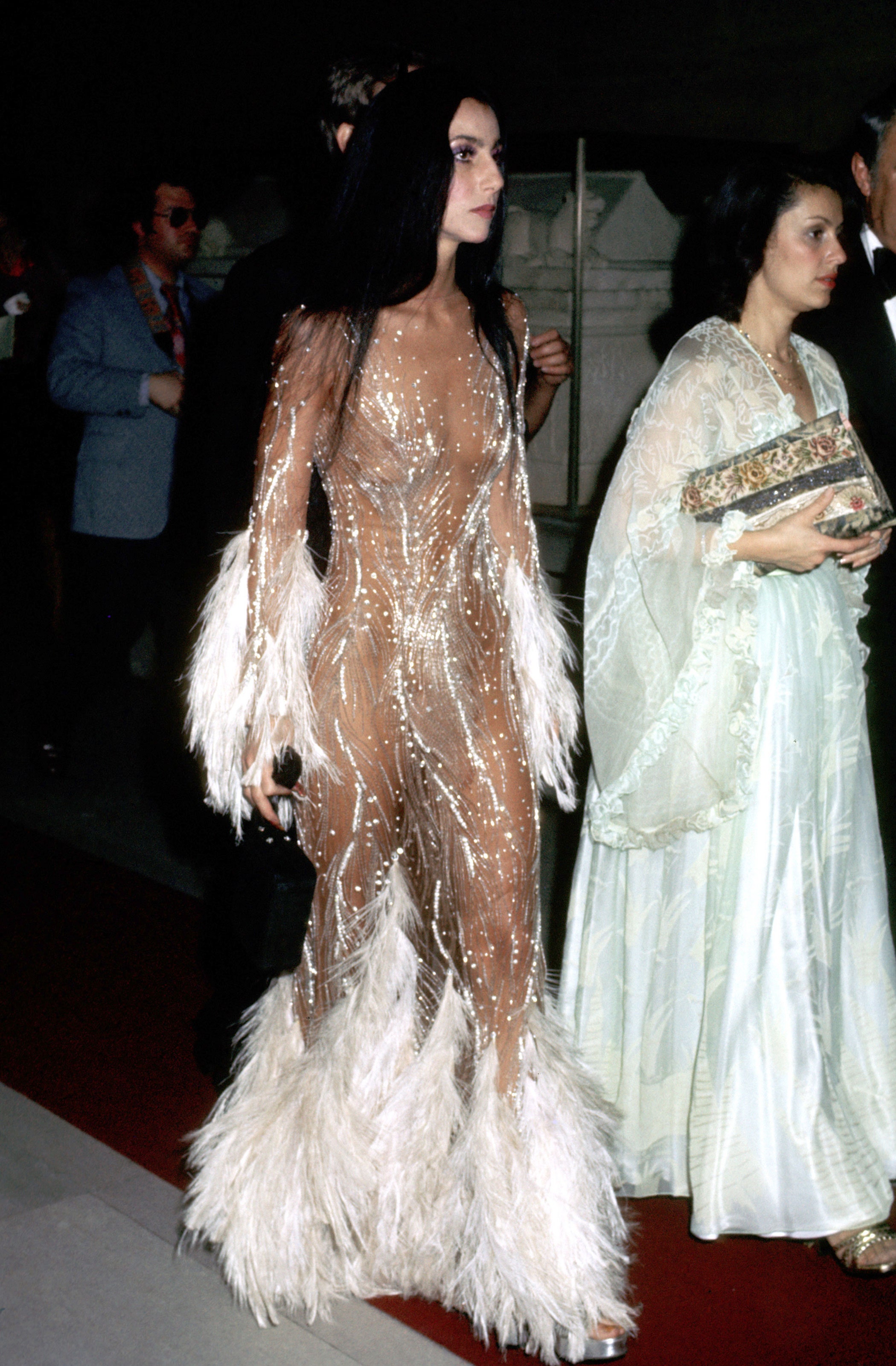 Cher wearing a white Bob Mackie feather dress